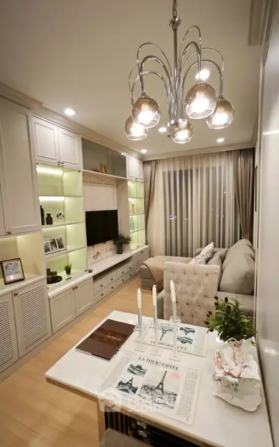 Elegant living room with modern chandelier and cozy sofa in stylish apartment