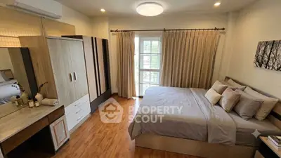 Spacious bedroom with modern decor and ample natural light, featuring a comfortable bed and stylish wardrobe.