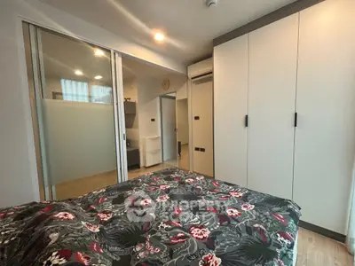 Modern bedroom with floral bedding and sleek wardrobe design