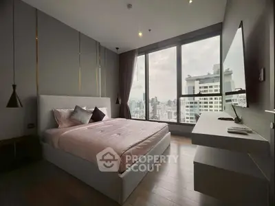 Luxurious bedroom with stunning city view, featuring modern decor and floor-to-ceiling windows for natural light.