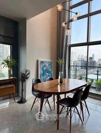 Stylish dining area with city view, modern furniture, and large windows for natural light.