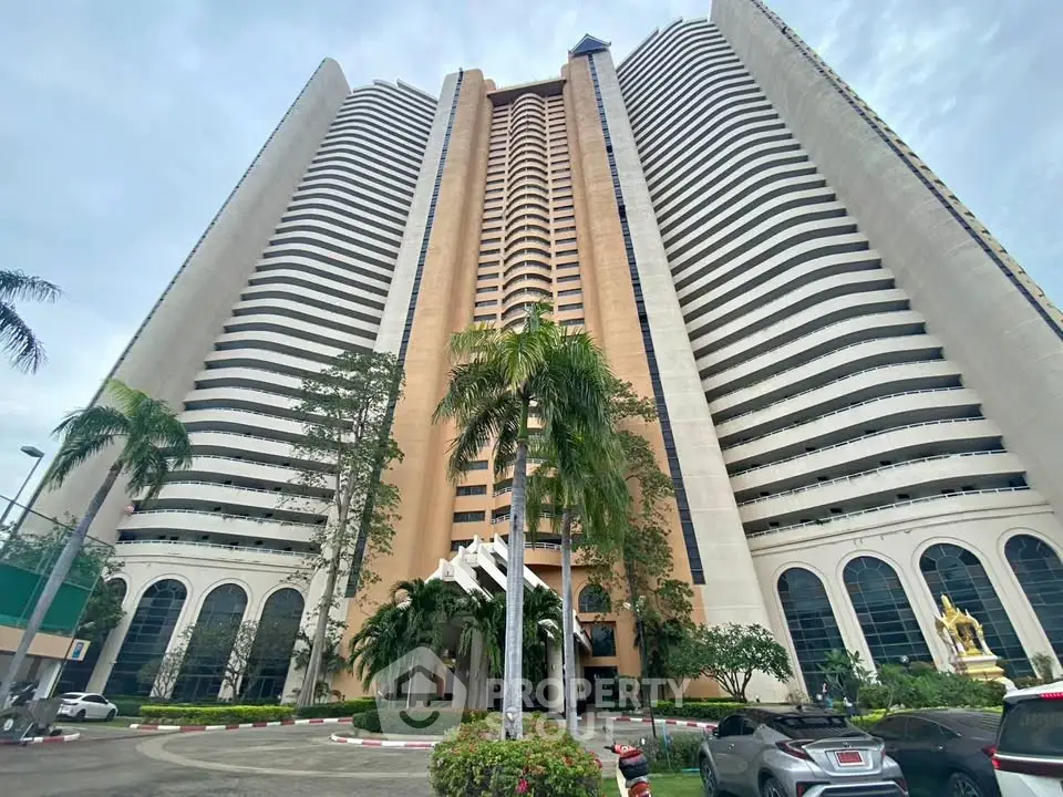 Stunning high-rise building with modern architecture and lush landscaping, perfect for luxury urban living.