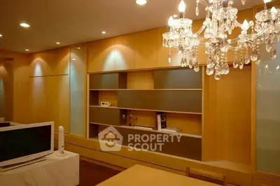 Elegant living room with chandelier and built-in wooden shelves