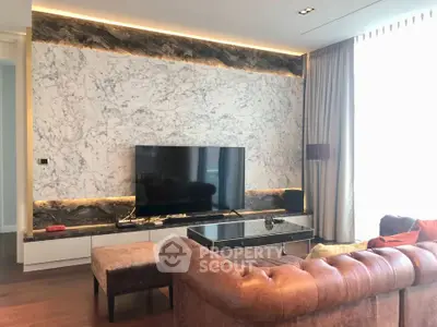 Luxurious living room with marble accent wall and elegant leather sofa