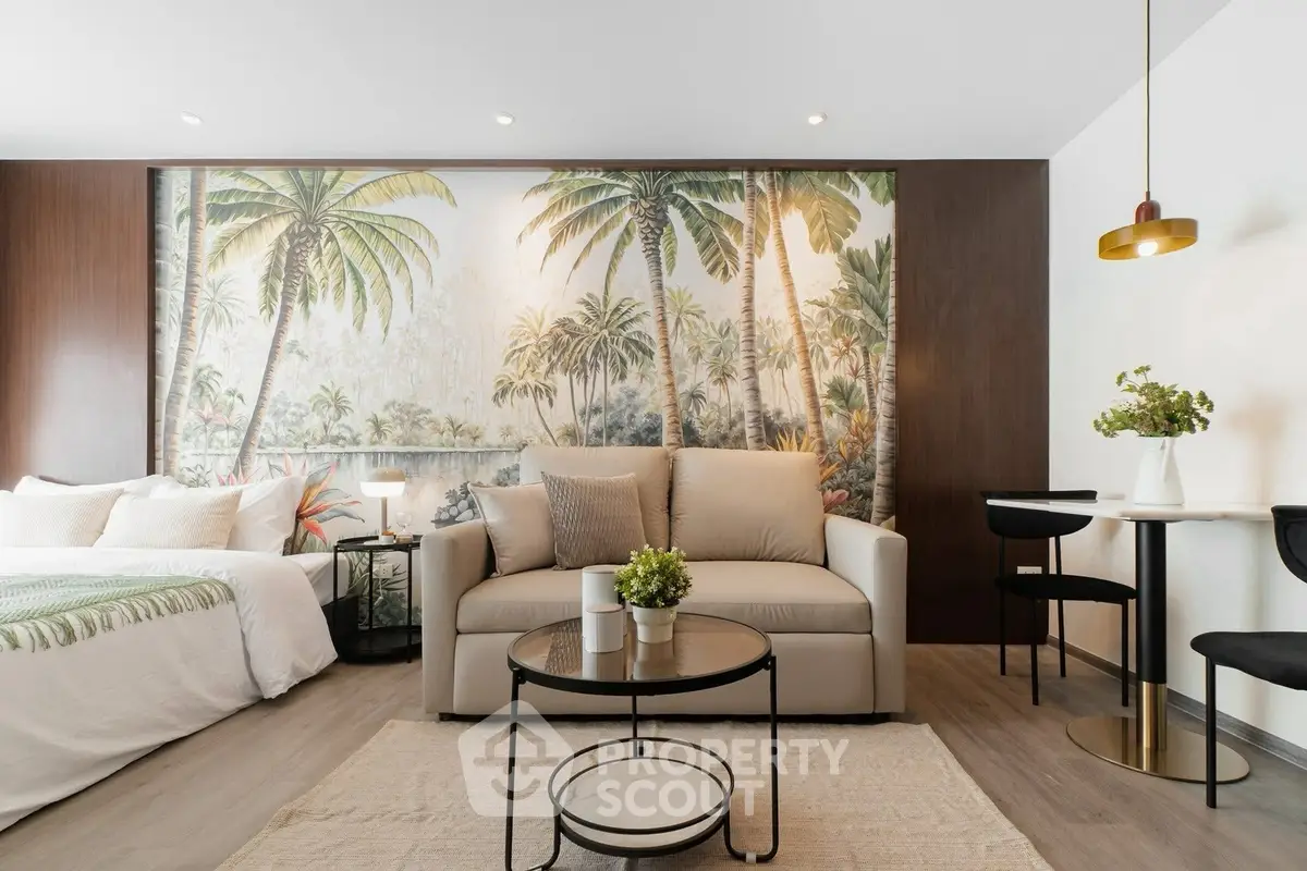 Stylish studio apartment with tropical-themed decor and modern furnishings.