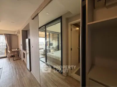 Modern apartment interior with glass partition and wooden flooring