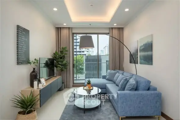 Modern living room with blue sofa and city view, perfect for urban living.