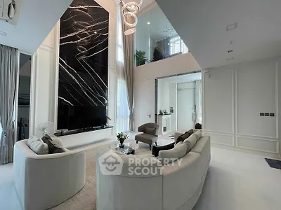 Luxurious modern living room with high ceilings and elegant marble fireplace
