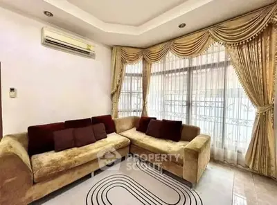 Luxurious living room with elegant curtains and plush sofa set
