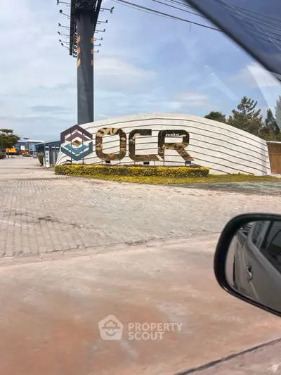 Modern commercial building exterior with unique architectural design and prominent signage.
