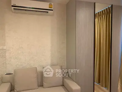 Cozy living room with modern air conditioning and stylish sofa, perfect for relaxation.