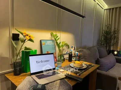 Cozy living room with stylish decor and modern workspace setup.