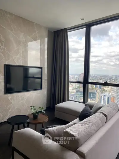 Luxurious living room with stunning city view, featuring modern decor and floor-to-ceiling windows.