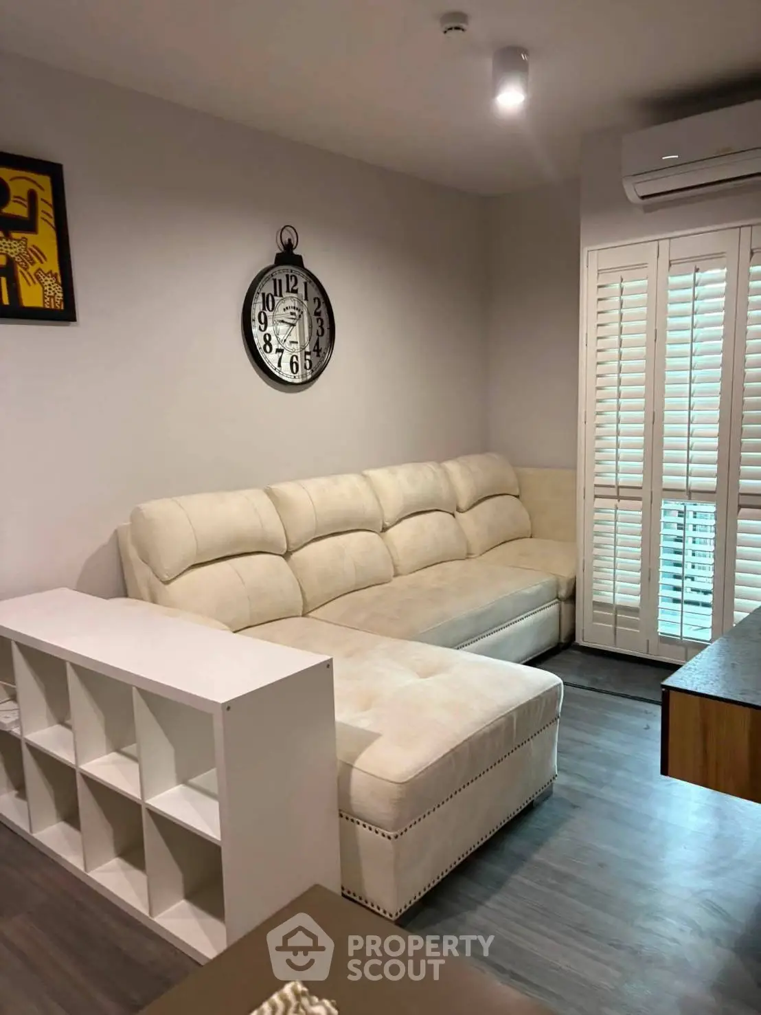 Cozy living room with plush sectional sofa and stylish decor in modern apartment.