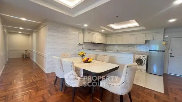 Spacious kitchen with dining area and modern appliances in elegant home.