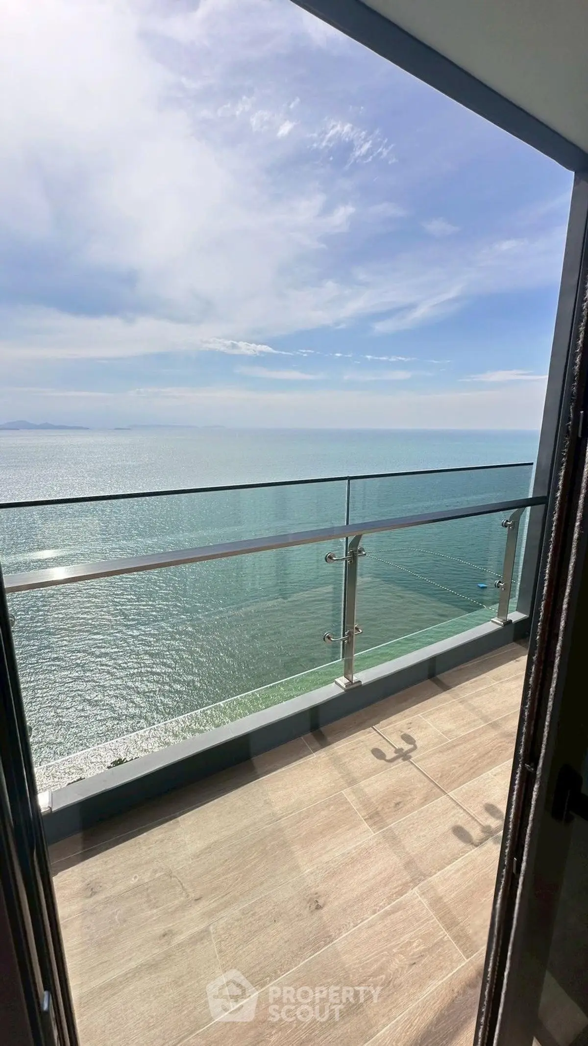 Stunning ocean view from modern balcony with glass railing