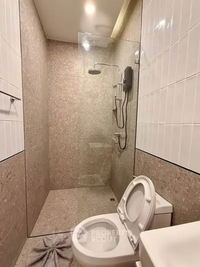 Modern bathroom with glass shower enclosure and sleek fixtures