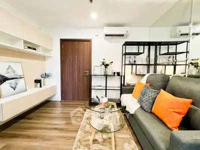 Modern living room with stylish decor, cozy sofa, and elegant shelving in a contemporary apartment.