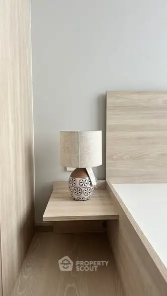 Modern bedroom with stylish wooden furniture and decorative lamp