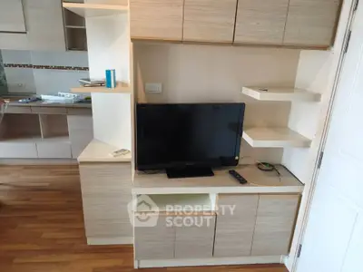 Modern living room with built-in TV cabinet and wooden flooring
