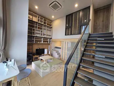 Modern duplex living room with stylish staircase and built-in shelving