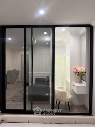 Modern interior with glass partition and elegant decor in a stylish living space.