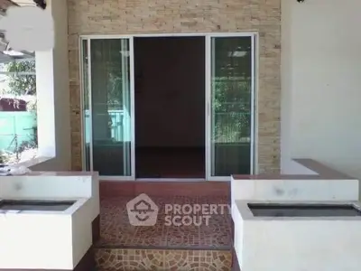 Charming entrance with sliding glass doors and stone facade, perfect for welcoming guests.