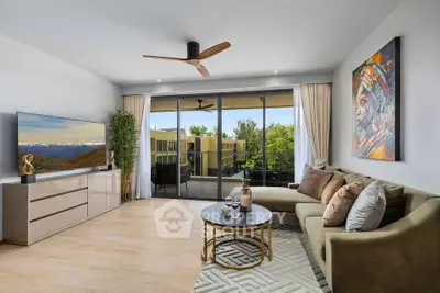 Modern living room with large windows and balcony view, featuring stylish decor and comfortable seating.