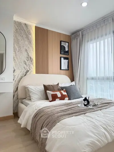Luxurious bedroom with modern decor, cozy bedding, and elegant lighting in a stylish apartment.