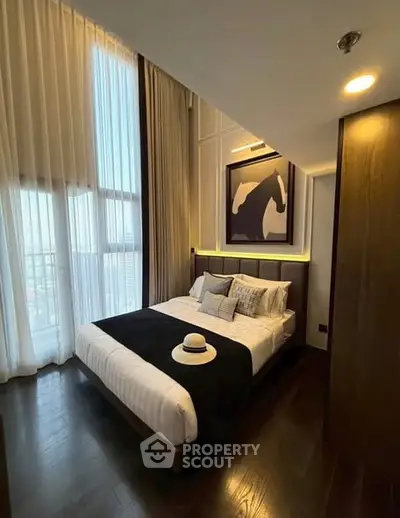 Luxurious bedroom with high ceilings and elegant decor in modern apartment