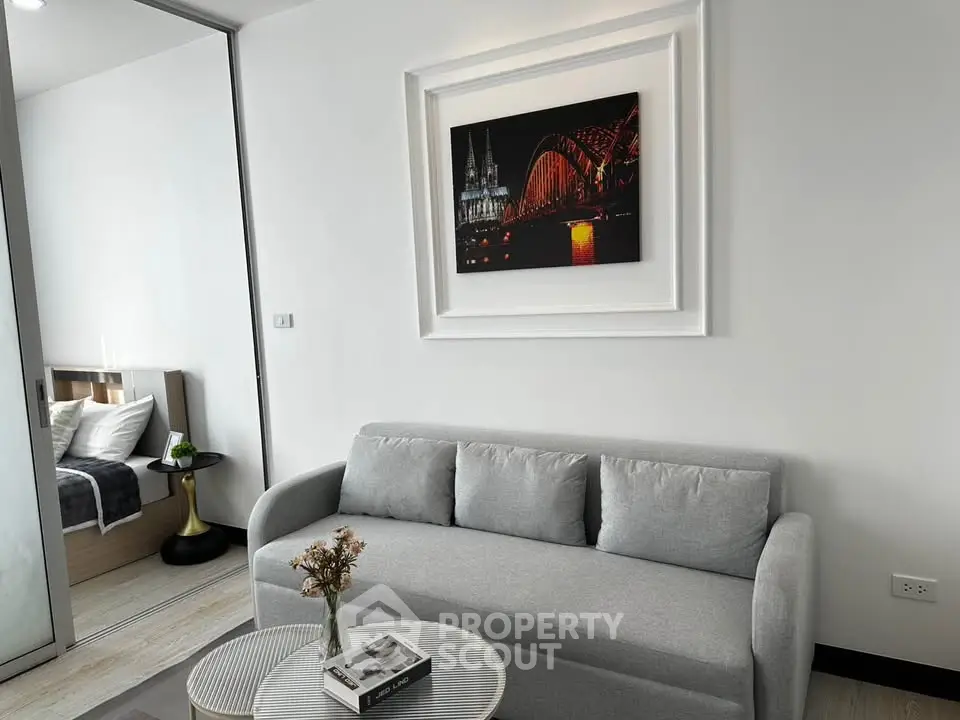 Modern living room with gray sofa and stylish decor in a contemporary apartment.