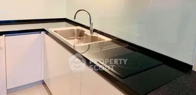 Modern kitchen with sleek black countertop and built-in electric stove