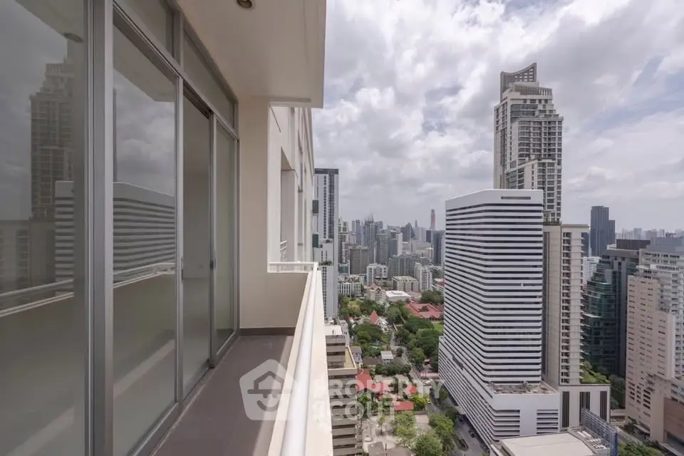 Stunning cityscape view from a high-rise balcony, showcasing modern architecture and urban living.