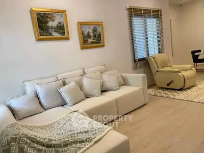 Cozy living room with plush sofa and elegant decor, perfect for relaxation.