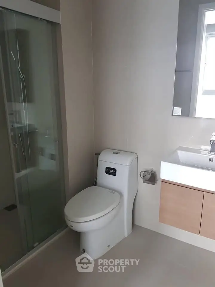 Modern bathroom with sleek fixtures and glass shower enclosure