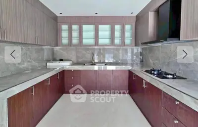 Modern kitchen with sleek cabinetry and gas stove in luxury home