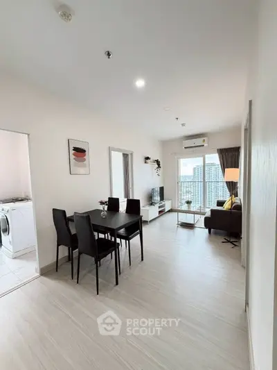 Modern open-plan living room with dining area and city view