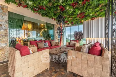 Luxurious living room with lush greenery ceiling and elegant wicker furniture, offering a serene ambiance.