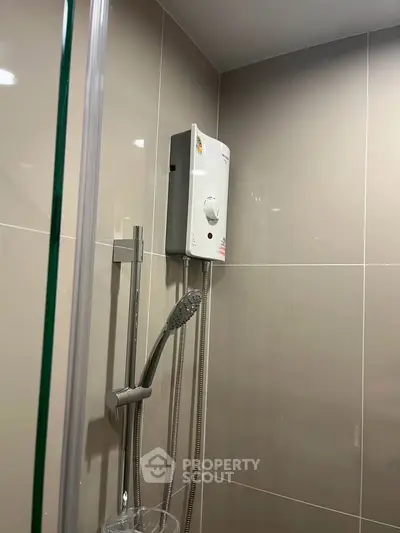 Modern bathroom with sleek shower and water heater, perfect for a contemporary home.