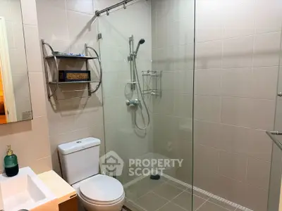Modern bathroom with glass shower enclosure and sleek fixtures