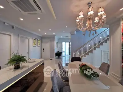 Luxurious open-plan living room with elegant chandelier and modern decor