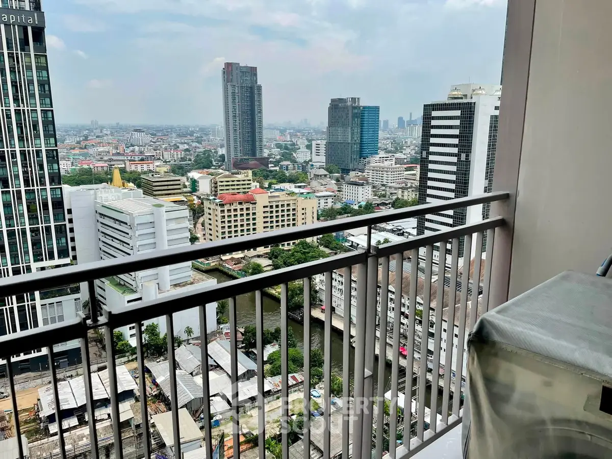 Stunning cityscape view from high-rise balcony overlooking urban skyline.
