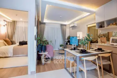 Modern open-plan living room and dining area with stylish decor and cozy bedroom view.