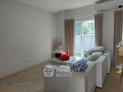 Cozy living room with modern white sofa and large window view