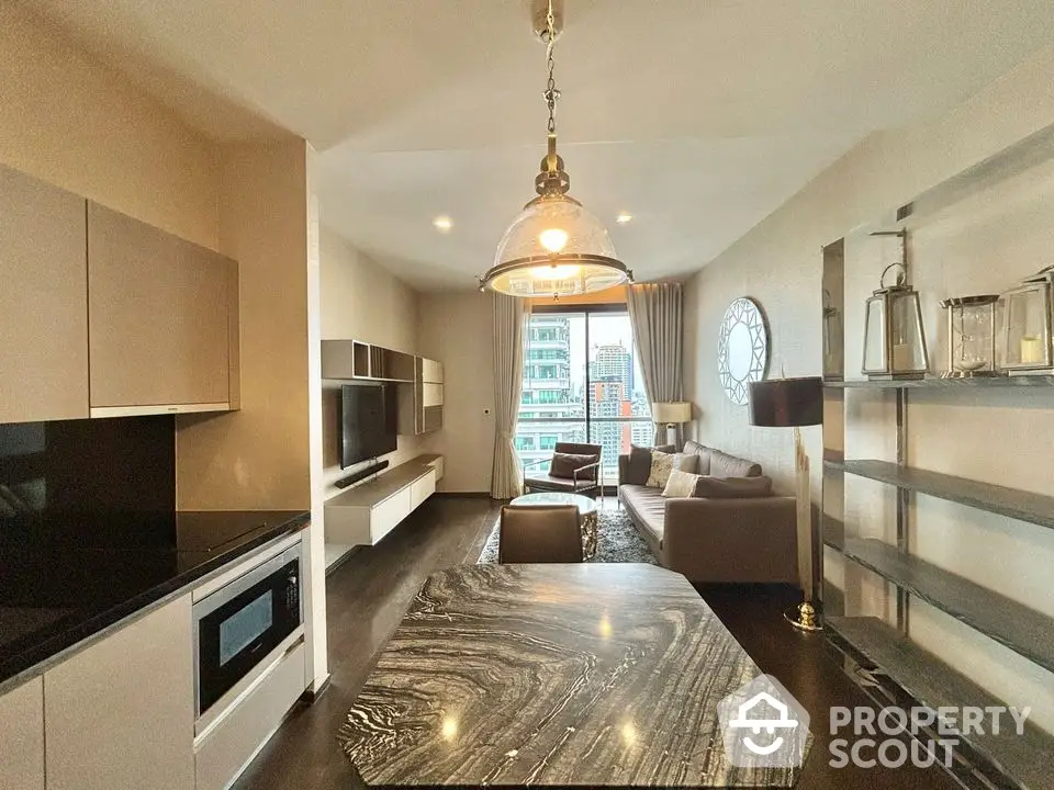 Modern living room with open kitchen and stylish decor in high-rise apartment.