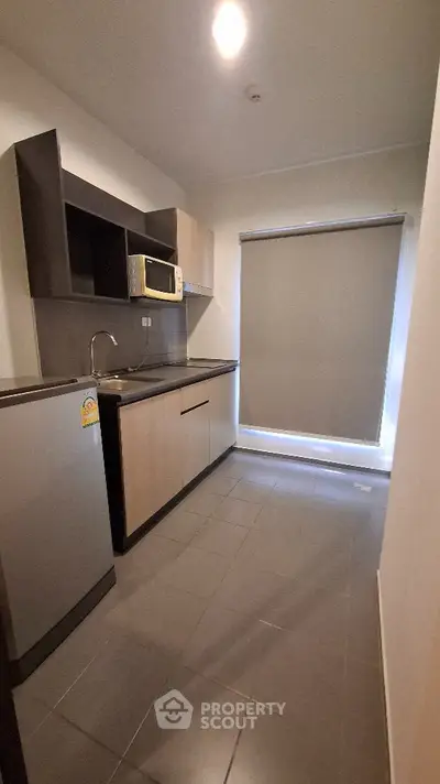 Modern compact kitchen with sleek cabinetry and stainless steel appliances