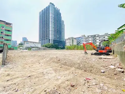 Prime urban land plot with high-rise building backdrop, ideal for development.