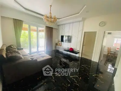 Luxurious living room with glossy black marble floors and elegant chandelier