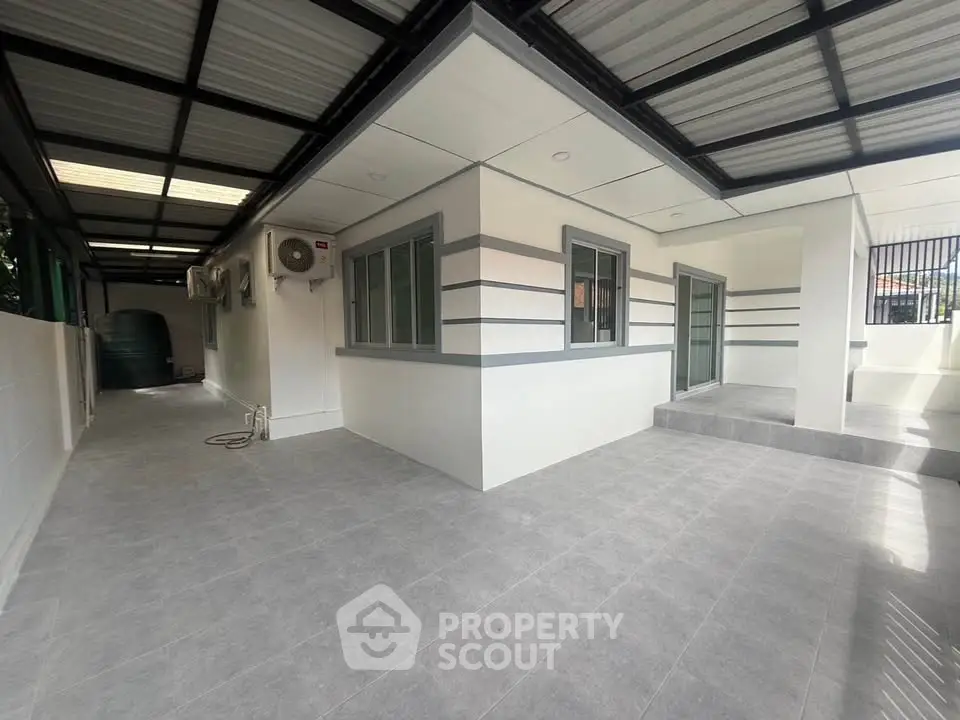 Modern exterior view of a sleek, minimalist home with covered patio and stylish design.