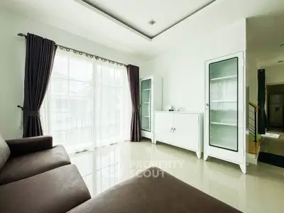 Spacious living room with modern furniture and large windows for natural light.